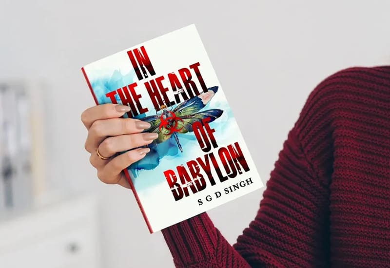 A person holding up an in the heart of babylon book.