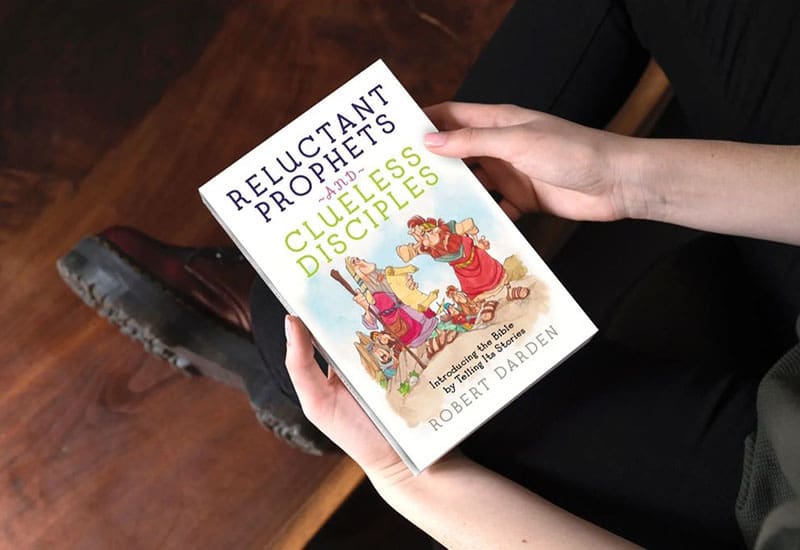 A person holding a book in their hands.