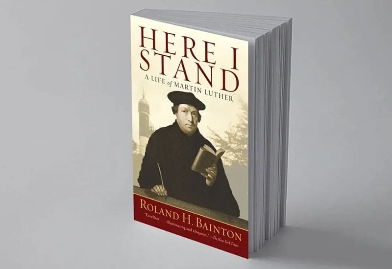 A book cover with an image of a man holding a book.