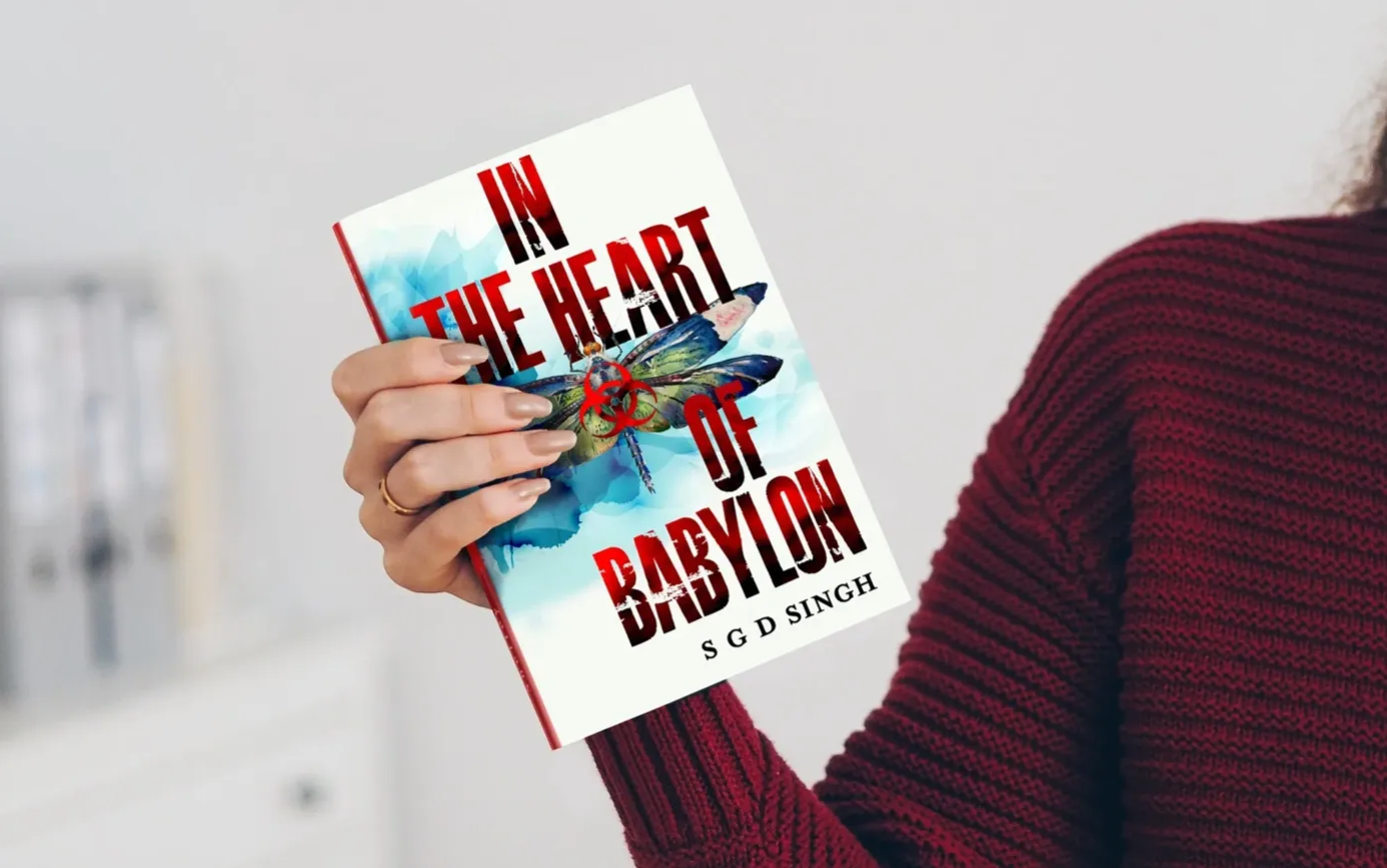 A person holding up an in the heart of babylon book.